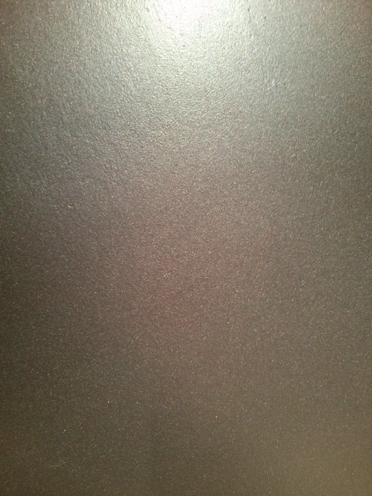 A pearlescent silver wall, fine mica lustre catching the light