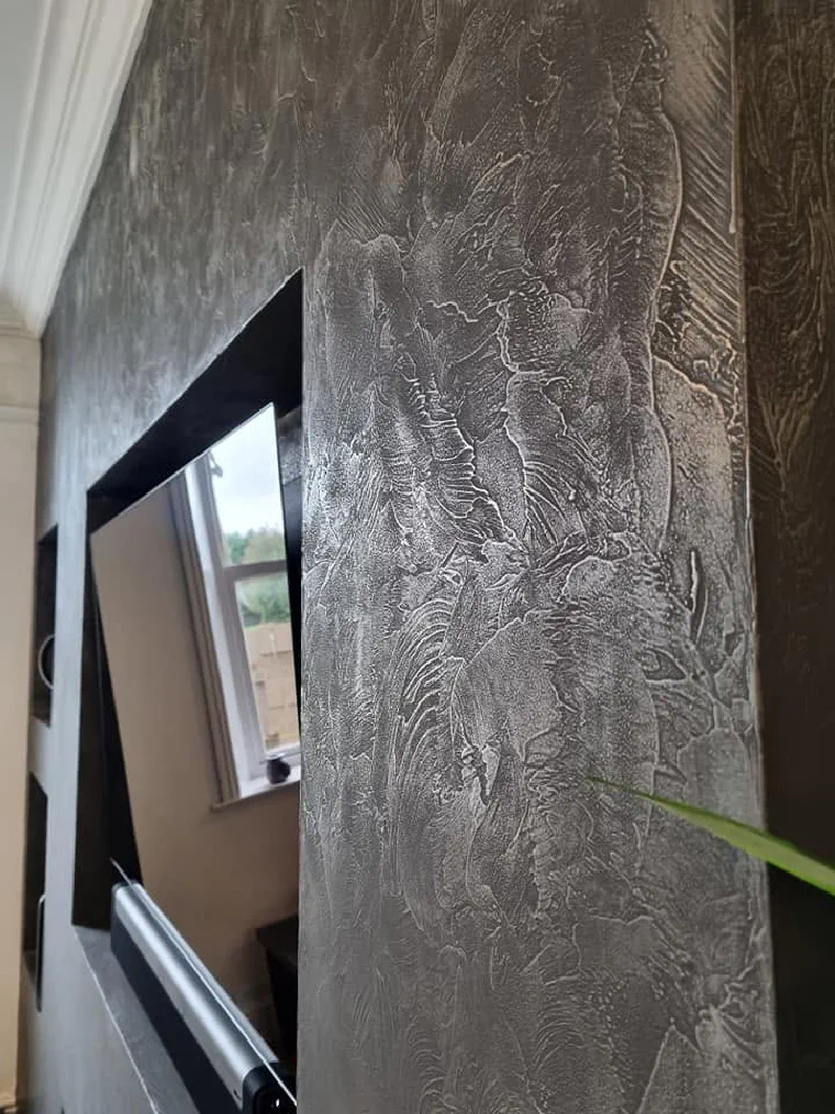 Pure nickel worked with a trowel, bright silver catching against darker grey