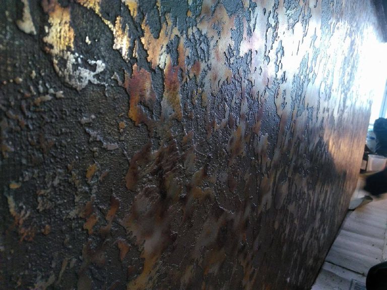 Foil over a heavy textured bronze — it turns blue, copper and gold as you move past it.