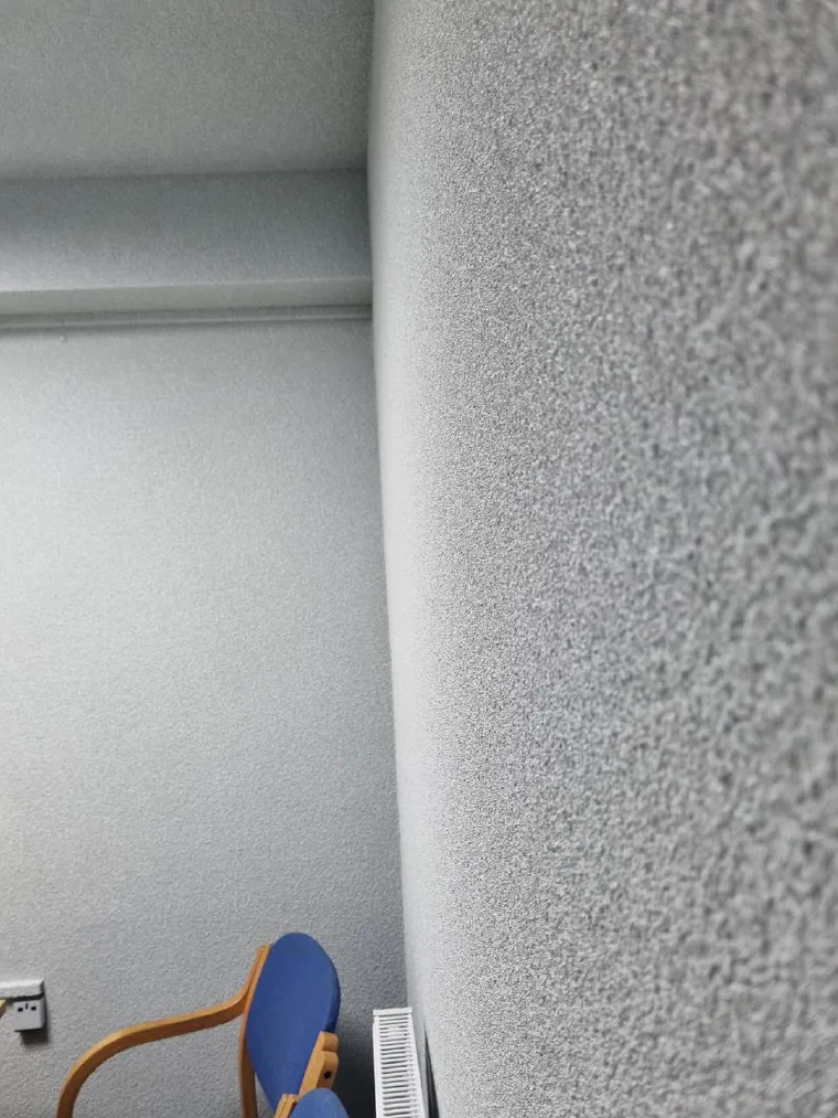 Sprayed cork on an office wall and ceiling, about 8mm finished