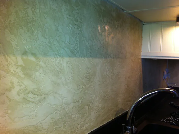 A plastered wall running from soft green through to cream, with cloudy tonal movement