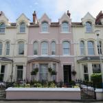 The finished front elevation head-on, hanging baskets across the bay