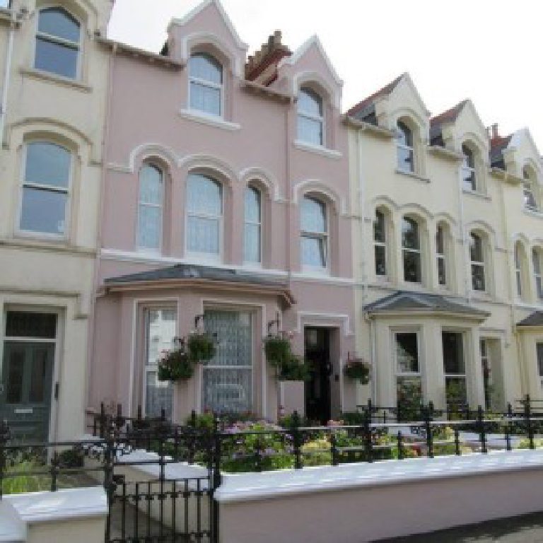The finished pink elevation seen along the terrace, arched window heads and moulded surrounds