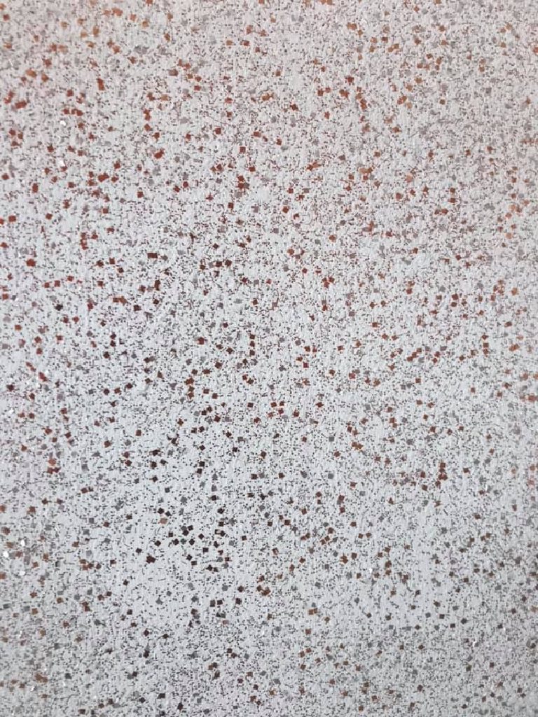 Fine copper and red fleck through a pale ground
