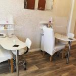The nail stations against the sparkling cream wall