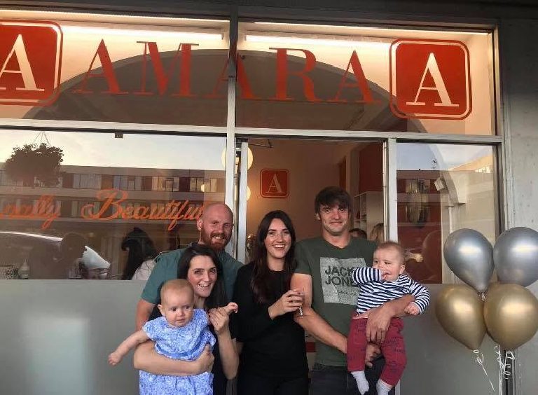 The Amara shopfront on opening day with the family outside and balloons at the door