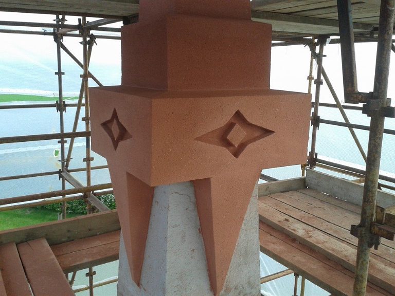 The rendered capital with four point crosses recessed into it, the section below still to be finished