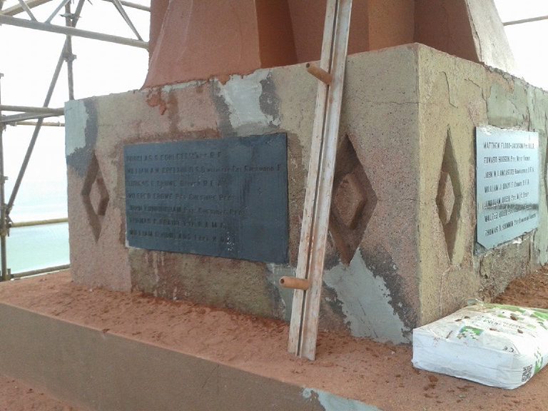 The stone plinth stripped back and patched, with the plaques left in place