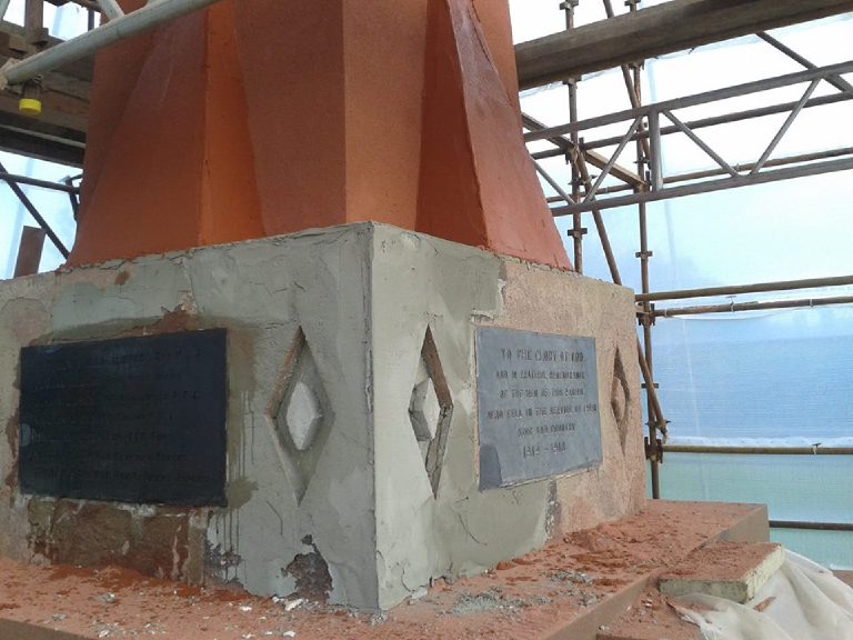 Base coat worked around the plaques, the shaft above already in its terracotta finish