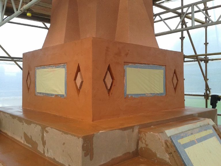 The top coat on the plinth with the masking still taped over the plaques