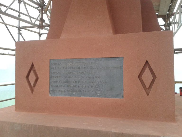 The finished plinth in terracotta render, with a plaque and a recessed diamond either side