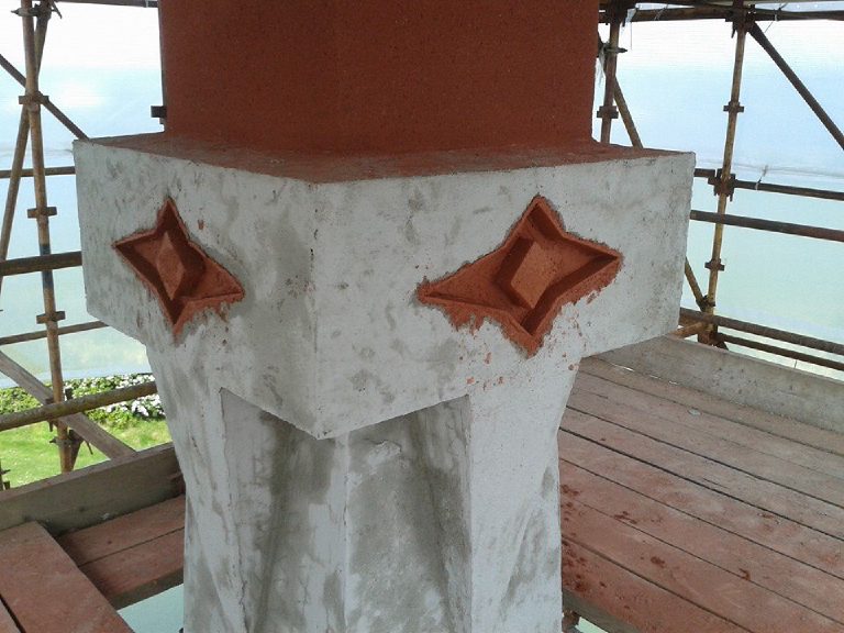 The capital in grey base coat with the four point motifs already formed up in terracotta