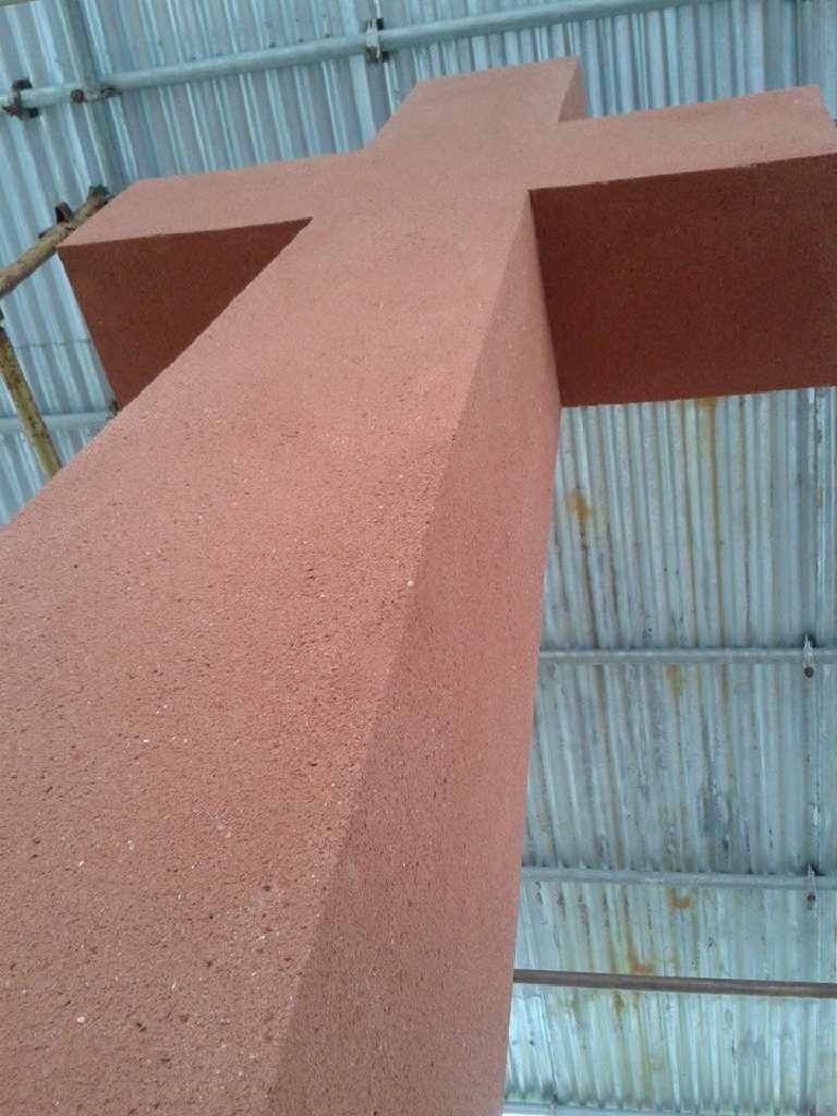 Close view along a rendered cross arm, showing the even texture of the terracotta finish