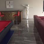 The finished room — bronze bar, red pool table and the sky ceiling