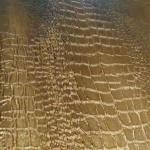 Close up of the crocodile print scales in gold and bronze