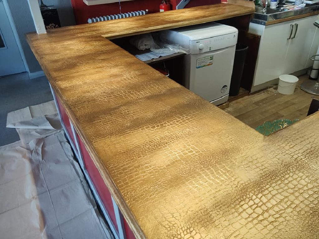 The L-shaped bar seen from above with the floor still papered up