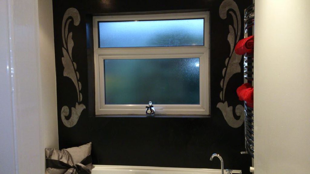 Black Marmorino featuring a stone coloured stencil, giving a stunning contrast
