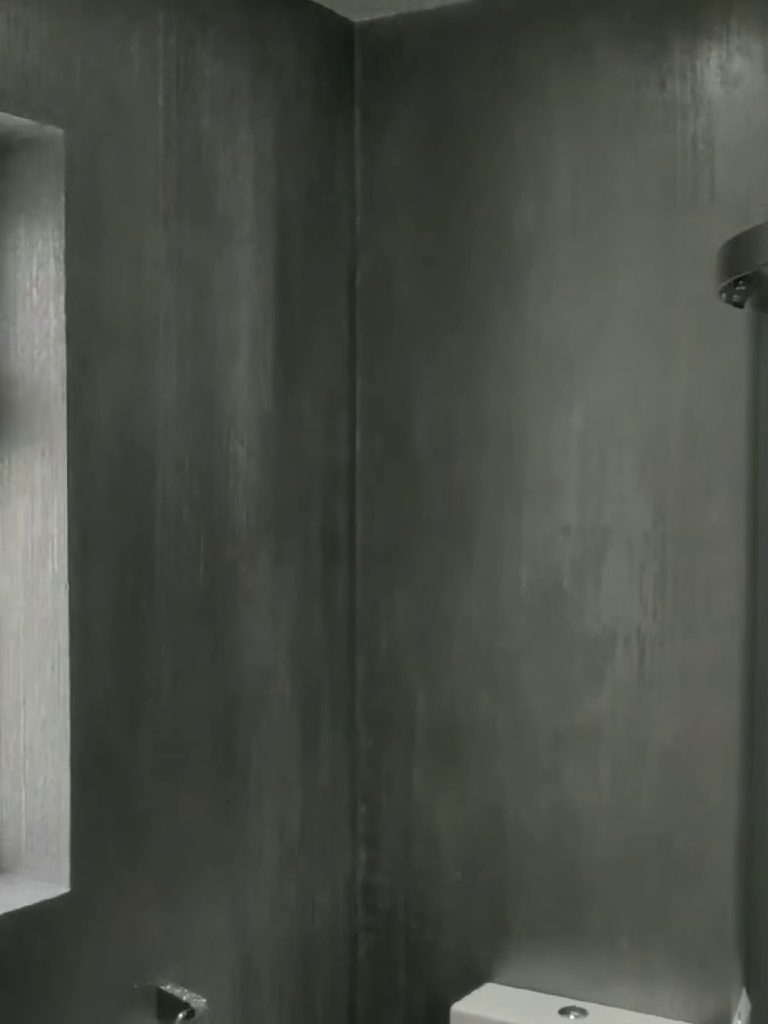 The internal corner beside the shower enclosure, plaster carried round unbroken