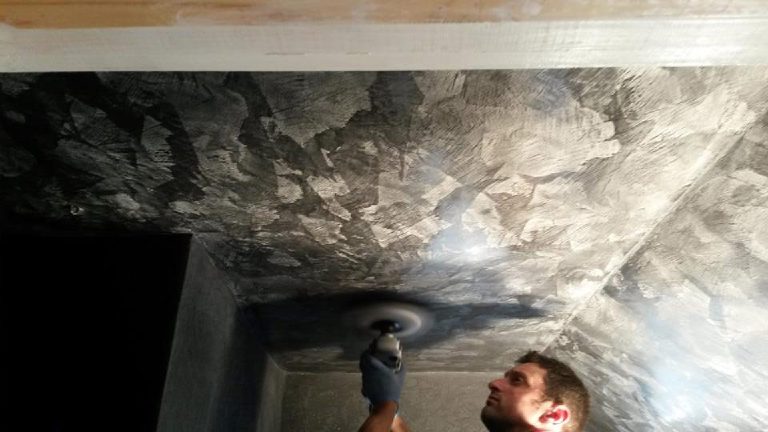 Applying black Marmorino plaster to walls and ceiling
