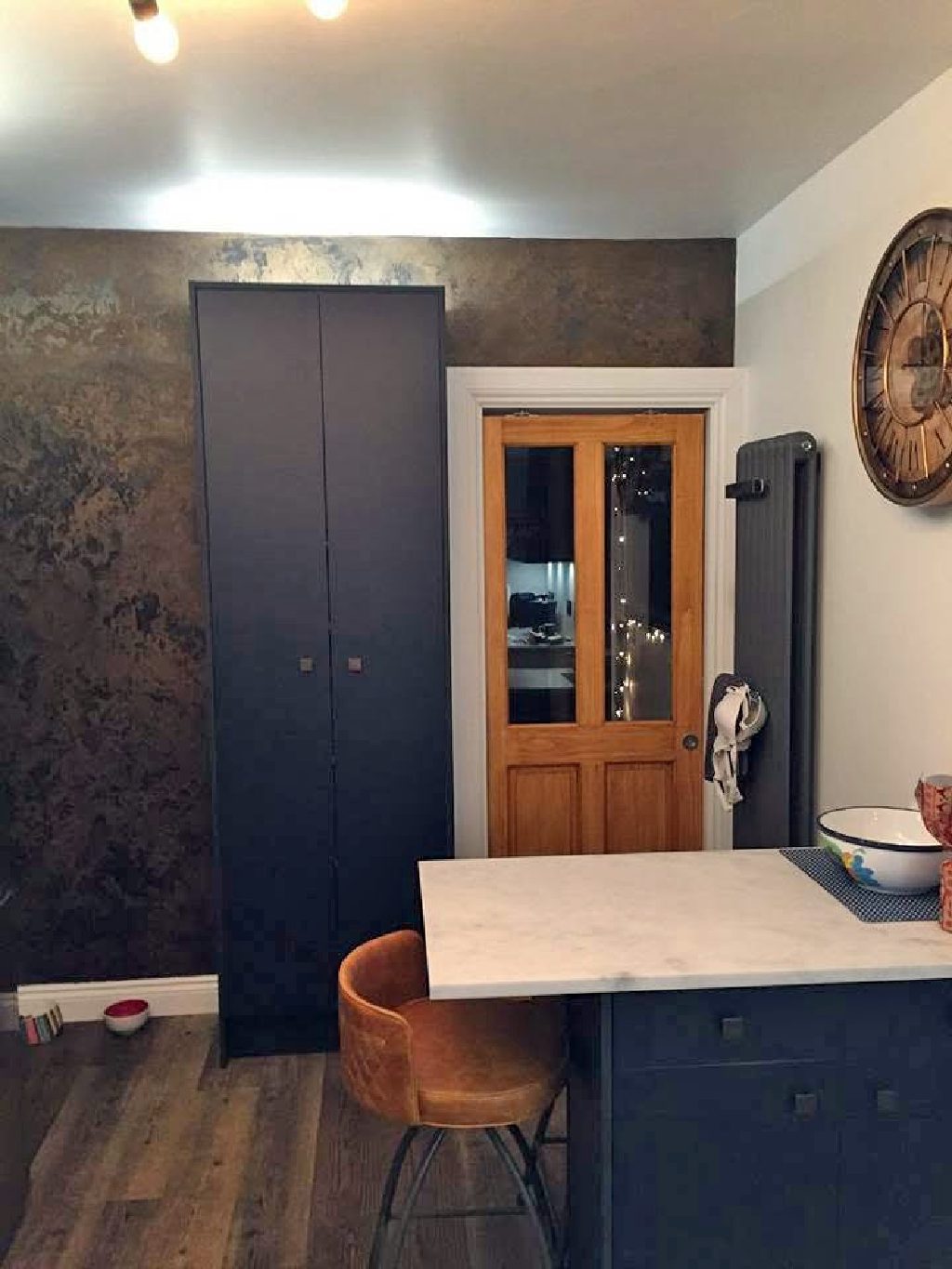 The feature wall with the wall clock it was made to match