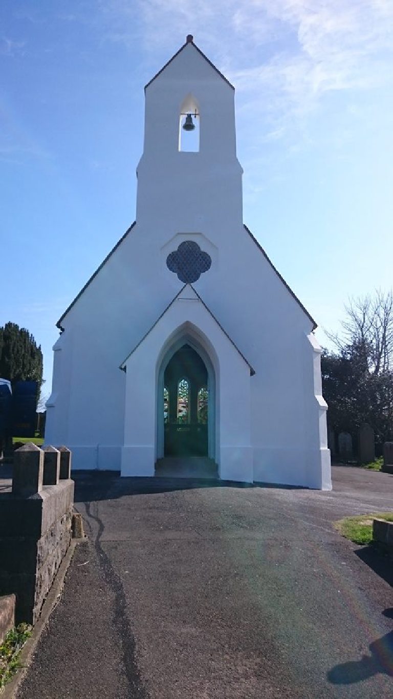 The chapel front elevation after restoration, quatrefoil window above the arched door