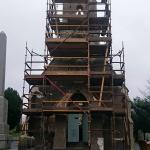 The chapel under scaffolding, walls stripped back, Venetian Plaster Company banner on the scaffold