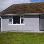 The front elevation of the bungalow after, in grey cork render