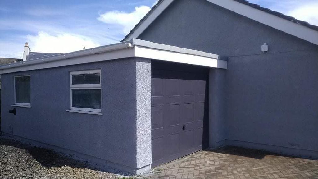The garage after, rendered grey with the up-and-over door in the same grey