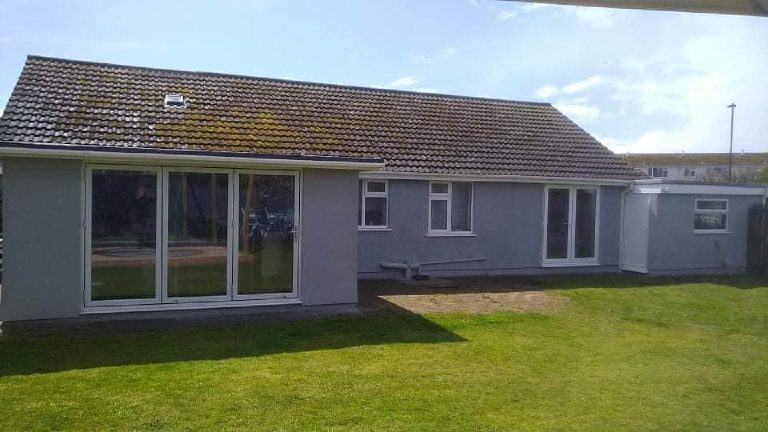 The whole rear elevation finished in grey, from the bifold extension along to the far end