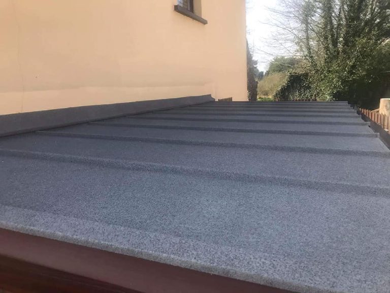 The sprayed cork surface running up the roof to the flashing at the wall