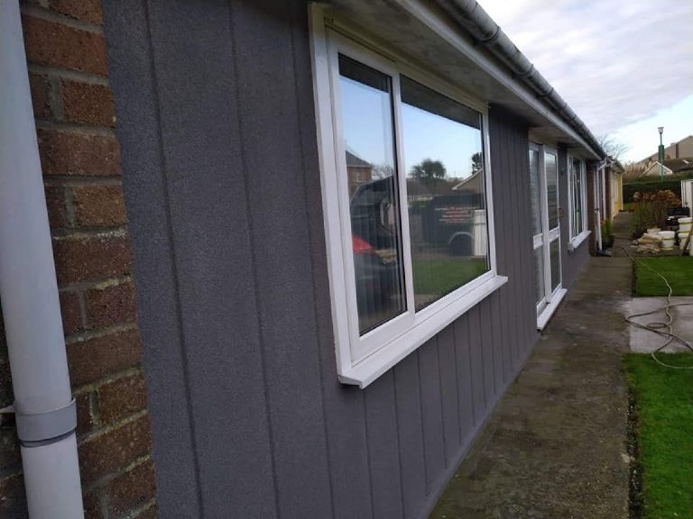 The cork render finishing neatly against the original brick corner of the bungalow