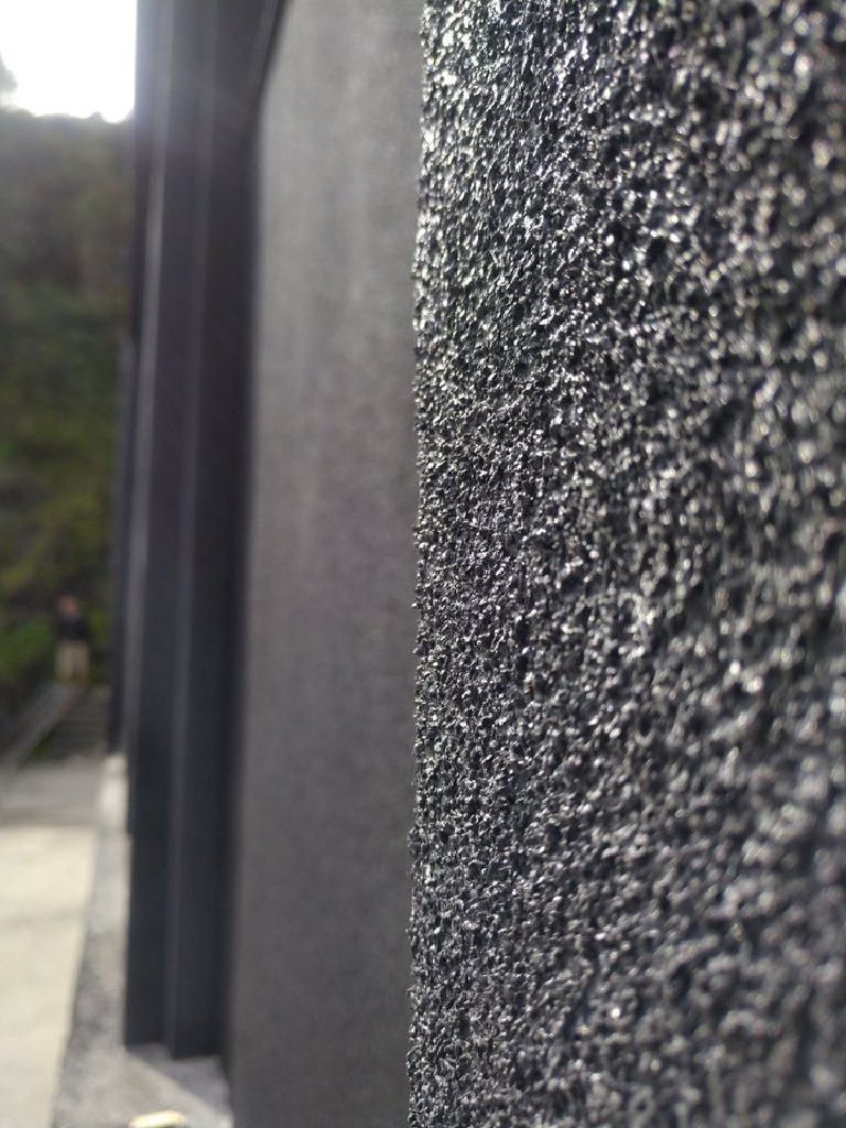 The sprayed cork texture up close beside a smooth edge
