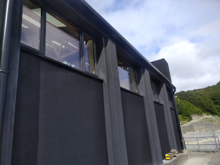 The gable end in cork render against the sky
