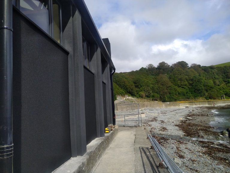 The building looking out towards the sea and the headland