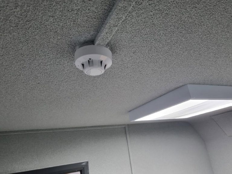 Close up of the sprayed cork on the ceiling, the cable run and detector coated over with it