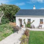 The finished cottage from the garden, benches out on the patio