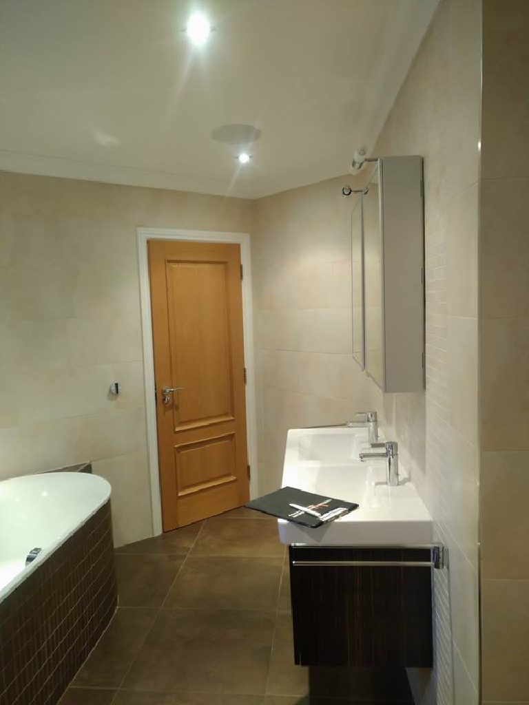 The tiled wall behind the basin before the quartz went on