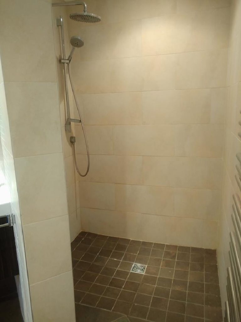 The tiled shower enclosure before the crystal quartz