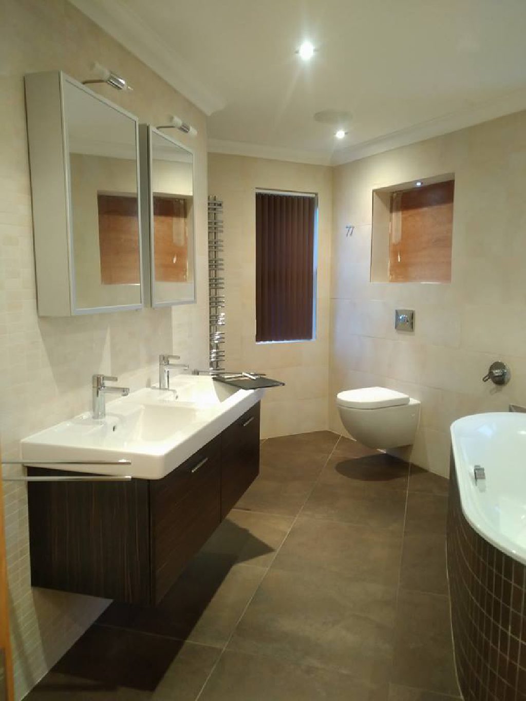 The same bathroom before, fully tiled in cream ceramic