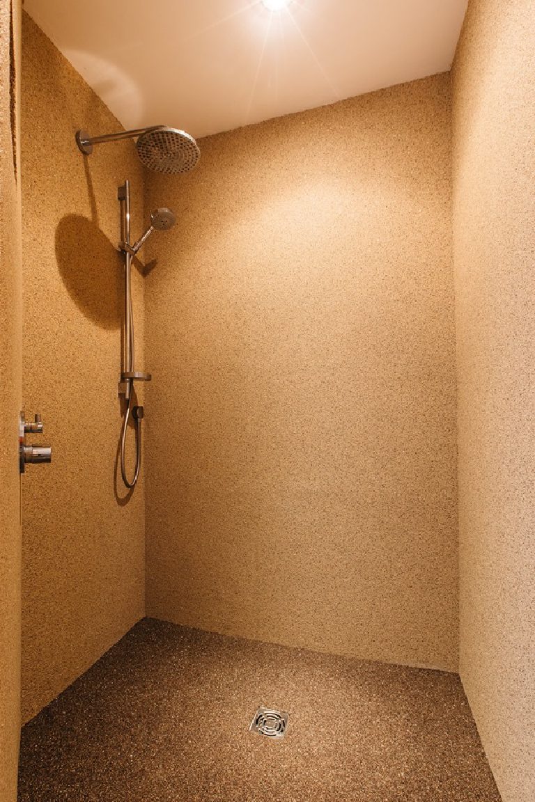 The shower enclosure finished seamlessly in crystal quartz