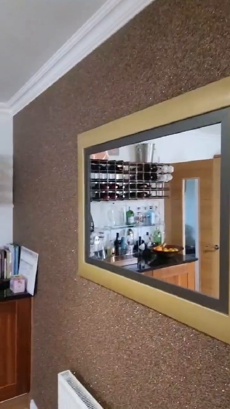 The feature wall in dark bronze Crystal Quartz, carried right up under the coving