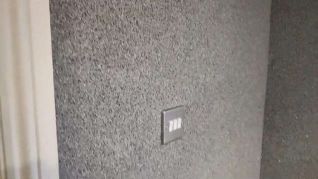 Close-up of the Crystal Quartz finish around a light switch