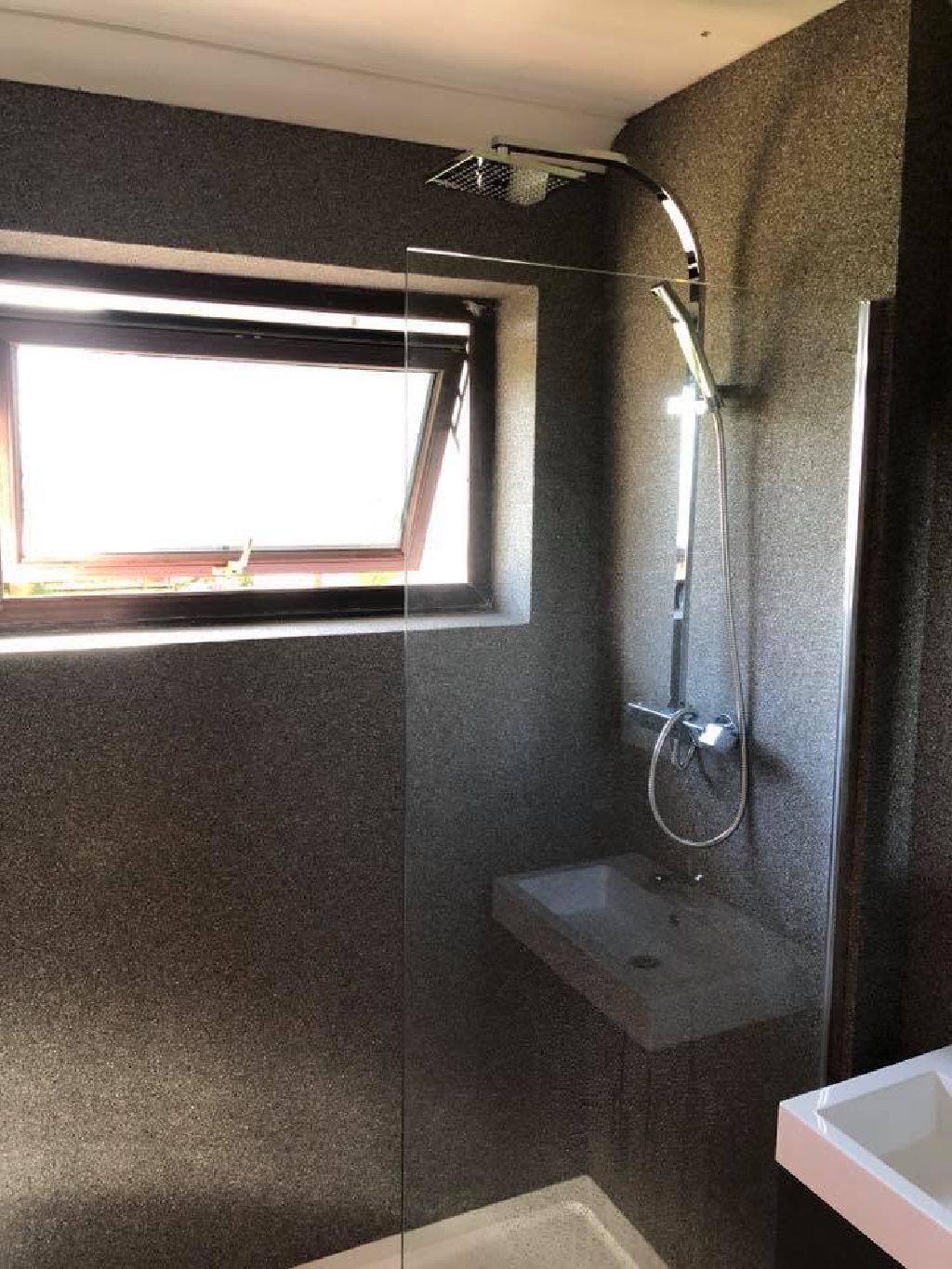 The shower room with daylight across the quartz wall