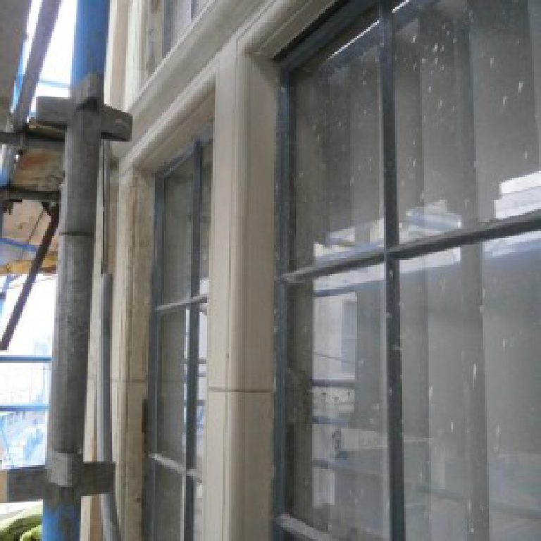 Part-restored window surrounds seen from the scaffold boards