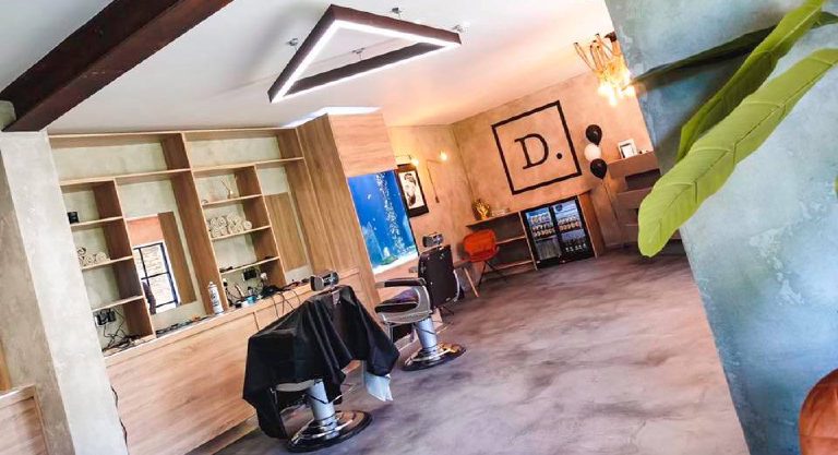 The salon from the doorway with chairs, mirrors and shelving