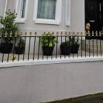 The finished front in Ecorend silicone render, mouldings and window surrounds picked out in white