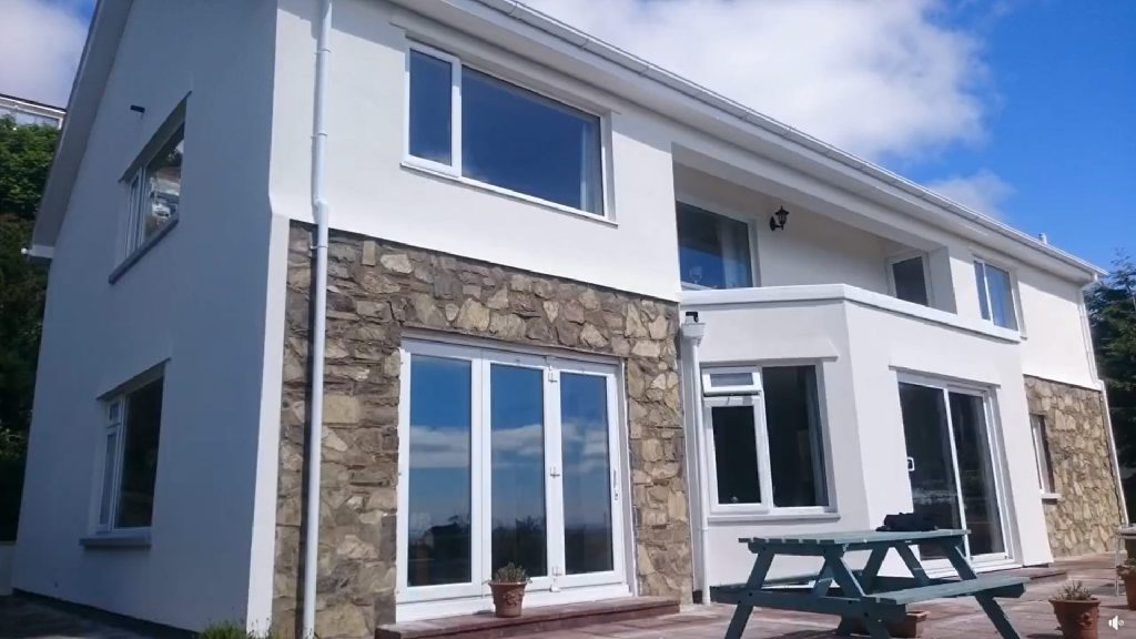 The finished exterior at Bradda Head, white render and stone detailing