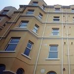 The refurbished facade of Piccadilly Court, ochre render and white details