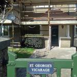 St George's Vicarage name plaque with the refurbished pebbledashed exterior behind