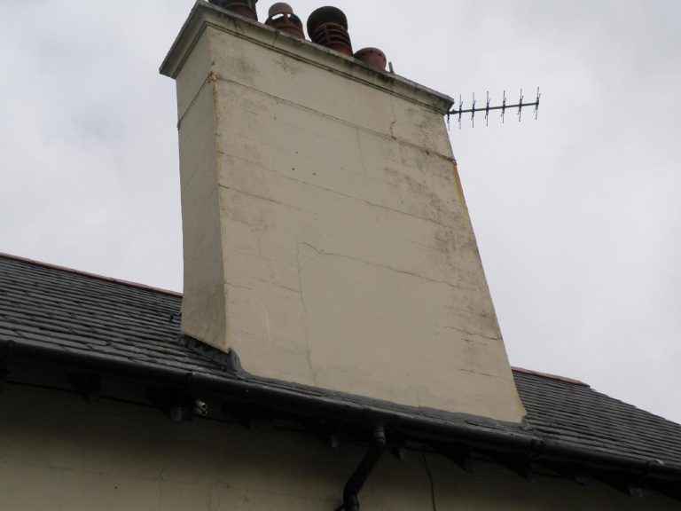 Weathered, cracked chimney stack before work